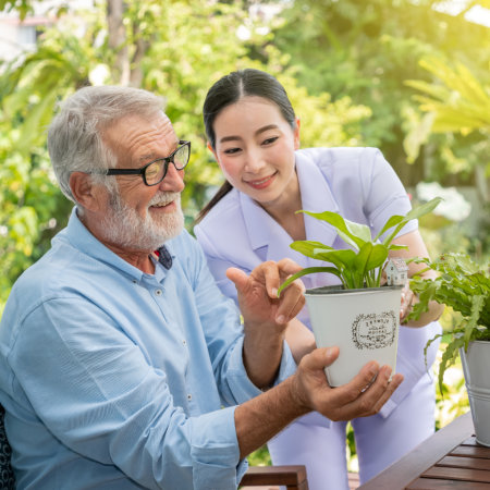 healthcare worker with elderly man outdoors