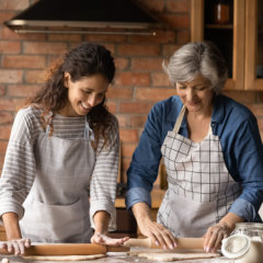 carer assisting an elderly woman in the kitchen