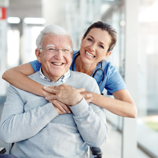 old man and nurse smiling together