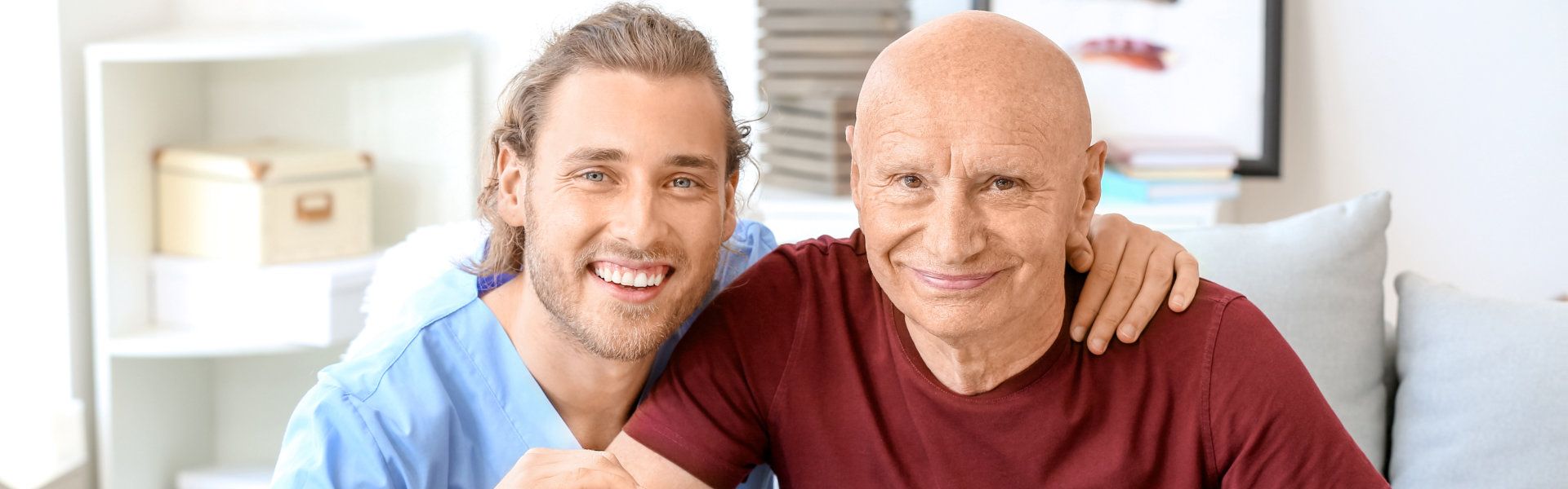 carer and elderly man smiling